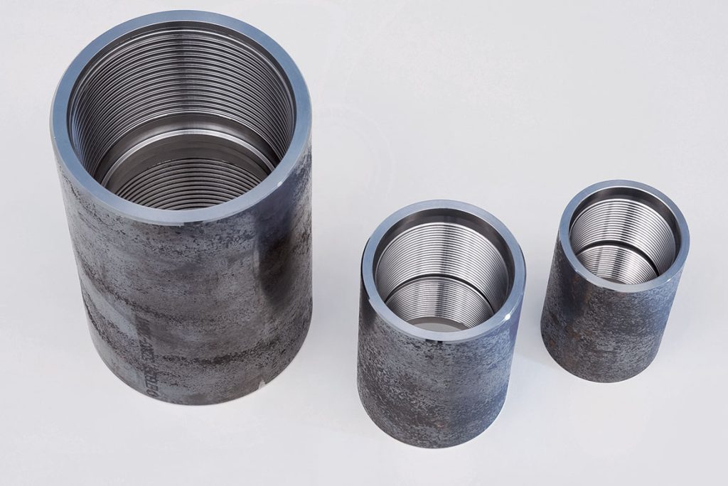 Close-up of finished machined couplings with clean and precise thread profiles, produced on the VSC 450 and VSC 500 lathes