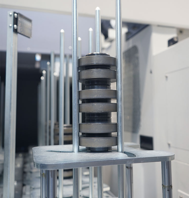 Stacker storage of the MSC 5 DUO with stacked workpieces on lift-out station for automatic gantry workpiece removal.