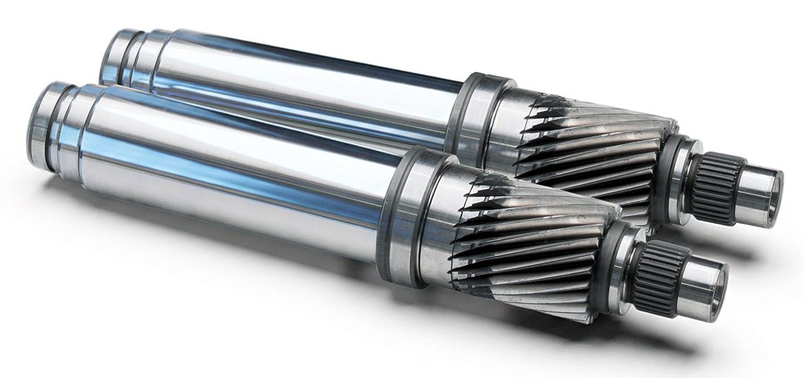 Monolithic rotor shaft with integral gear teeth, manufactured from a single piece. 