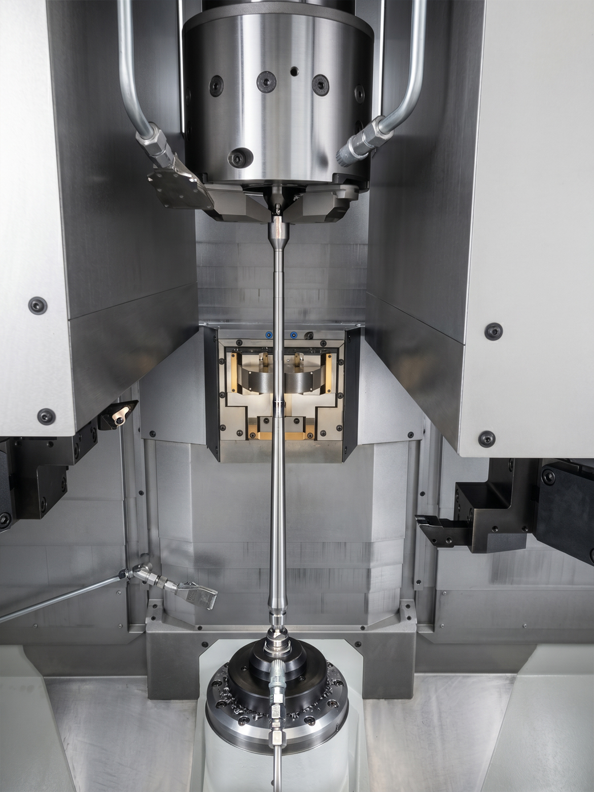 Work area of the EMAG VT 4. A long firearm barrel is clamped vertically.